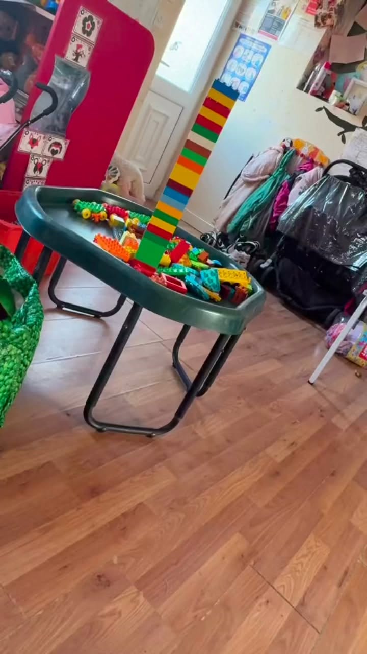 A home playroom building table with a tall colourful block tower